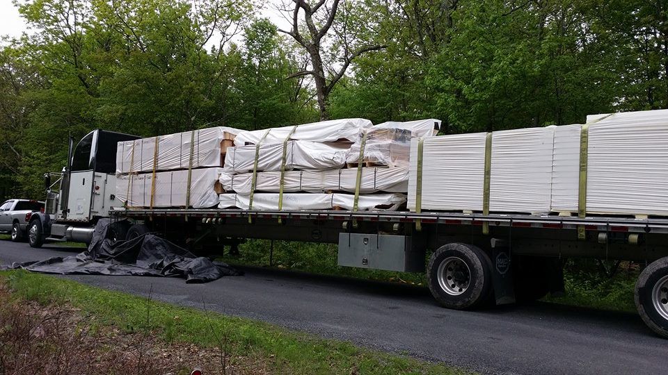 tractor trailer truck delivering log home, Timberhaven, delivery day, log homes, log cabin, custom built log home, laminated, kiln-dried