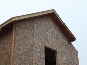 two-story post and beam home, closeup of roof SIPs being installed on custom post and beam home construction, post and beam homes, post and beam home design, Timberhaven Log Homes, log homes, log home, log cabins, log cabin kits, laminated, kiln dried, under construction