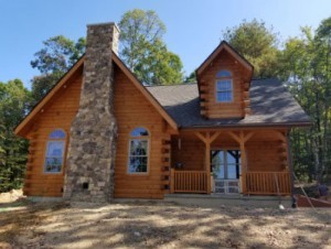 log home in the woods with stone chimney, log home dreams, log homes, log cabins, timber frame homes, laminated logs, engineered logs, floor plan designs, kiln dried logs, log cabins in Pennsylvania, Timberhaven Log Homes, Timberhaven Log & Timber Homes
