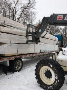 unloading truck of materials, built in the winter, road covered with snow, log home winter, winter build, building a log home in the winter, building a timber frame home in the winter, Timberhaven