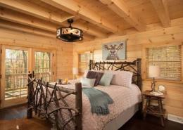 Log Cabin Master Bedroom Features Private Balcony