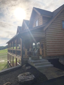 front porch of log home, farmhouse inspired log home, log home, log home living, log home exterior, log home cape cod, front porch, Timberhaven, kiln dried