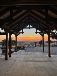 Beautifully framed sunset, Timber Frame Pavilion and Timber Frame Walkway, Barn at Wheatland Hills, Timberhaven, custom design project, timber frame wedding venue, timber frame special events venue
