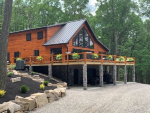 customized Keystone I log home, log home, log home in the woods, log home with lots of windows and deck, Timberhaven