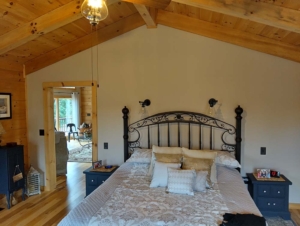 log home bedroom with cathedral ceiling, single-level log home, Timberhaven, log homes, single-level home design