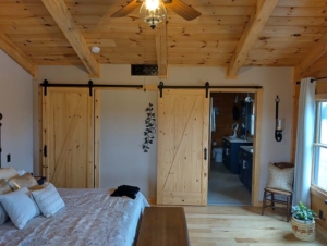 log home great room with barn doors, single-level log home, Timberhaven, log homes, single-level home design